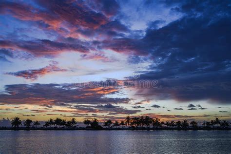 Colorful Sunset With Silhouettes Of Palm Trees On A Tropical Island In