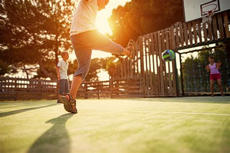 Kids Playing Football In The Schoolyard Stock Photo Download Image