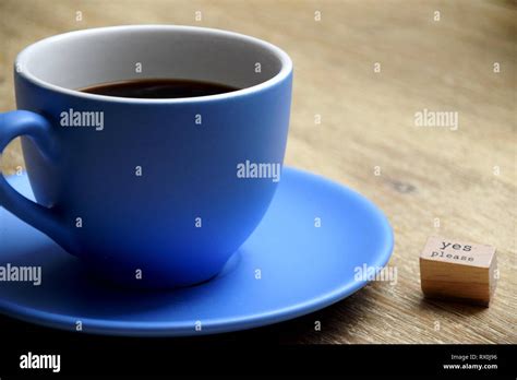 Blue Cup Of Coffee Next To A Sign Saying Yes Please Stock Photo Alamy