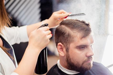 Hairdresser Woman Doing Hairstyle To Bearded Man In Barbershop Stock