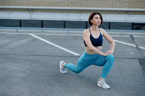 Female Runner Stretching After A Running Session In City Stock Image