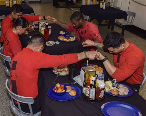 Sailors Pray Before Thanksgiving Dinner On The Mess Decks Of The Aircraft Carrier Uss Theodore