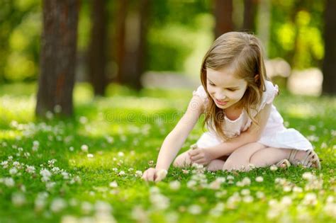 Cute Little Girl Sitting On A Clover Field Stock Photo Image Of Child
