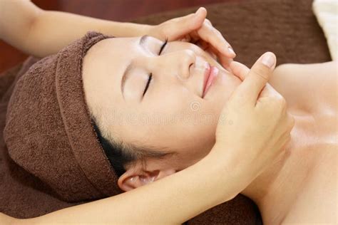 Beautiful Woman Enjoying A Massage In A Spa Center Stock Photo Image Of Facials Cute