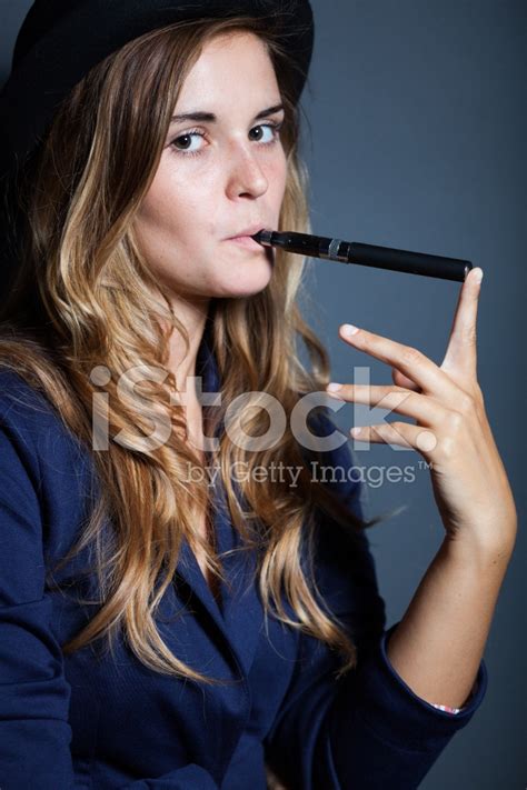 Elegant Woman Holding And Smoking E Cigarette Stock Photos