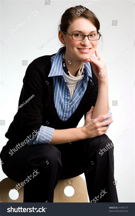 Business Woman Wearing Glasses Sitting On The Back Of A Modern Design