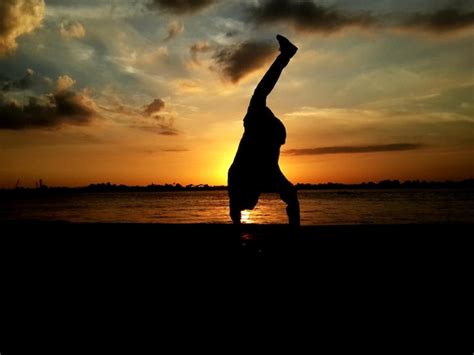 Premium Photo Silhouette Person Doing Handstand On Beach During Sunset
