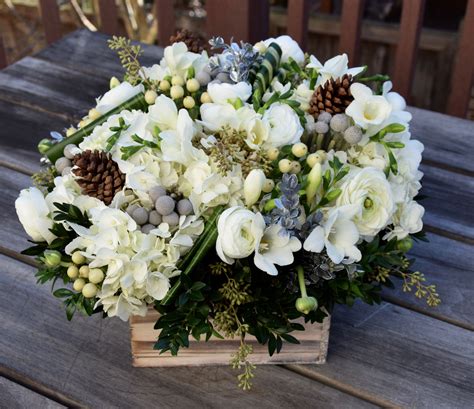 Winter Flower Arrangement In A Rustic Container With Lots Of Floral
