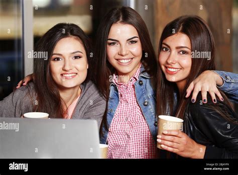 Best Friends With Laptop Together Sitting At Cafes Terrace Stock Photo