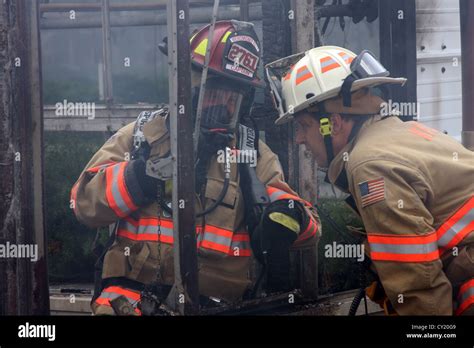 Two Firefighters Communicating At The Scene Of A Fire Stock Photo Alamy
