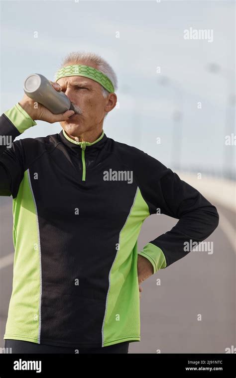 Caucasian Senior Man Drinking Water During Morning Workout Horizontal