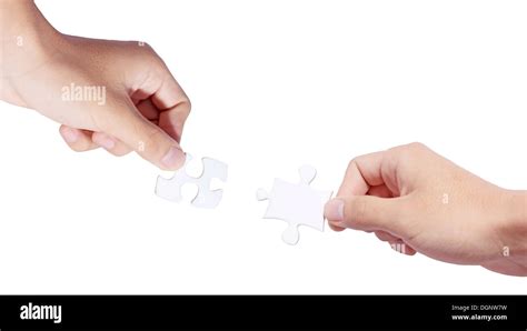 Two Hands Holding Puzzle Pieces And Connecting Them Stock Photo Alamy