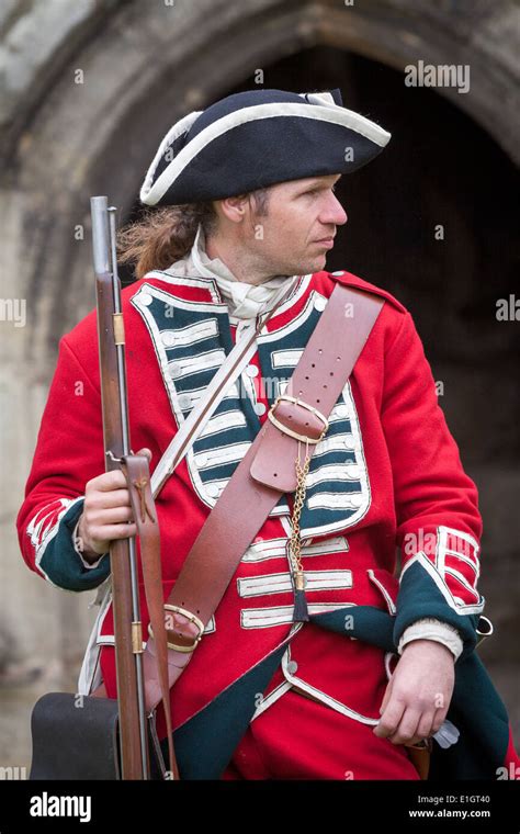 A Soldier Dressed In Traditional 17th Century English Army Redcoat