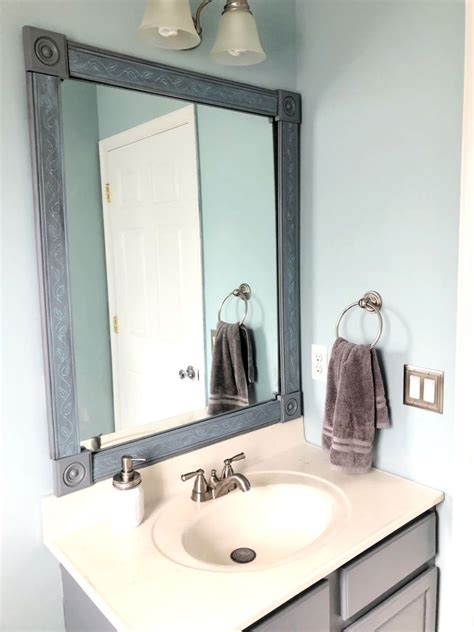 The frame covers right over clips that hold the mirror. DIY Bathroom Mirror Frame - One Room Challenge Week 4 ...