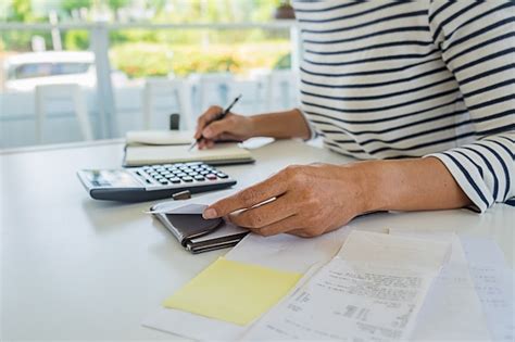 Premium Photo Woman With Bills And Calculator Woman Using Calculator