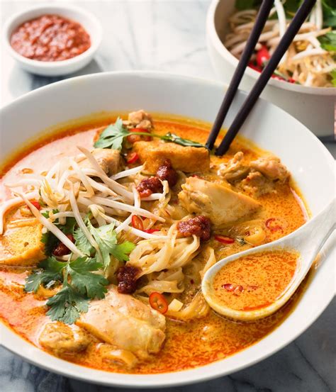 Laksa consists of thick wheat noodles or rice vermicelli with chicken, prawn or fish. laksa noodle soup - spicy malaysian curry coconut soup ...