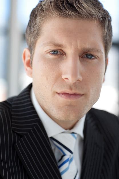 Premium Photo Young Attractive Businessman Looking At Camera