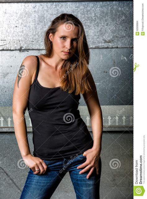 Trendy Woman In Blue Jeans Posing In The Grungy Underground Stock Photo