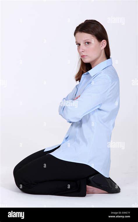 Woman Kneeling Down Cross Armed Looking Sulky Stock Photo Alamy