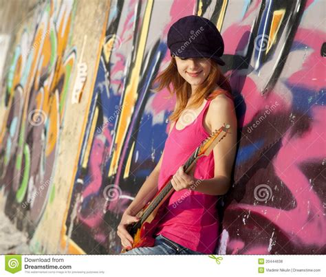 Girl With Guitar And Graffiti Wall Royalty Free Stock