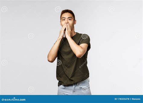 Portrait Of Shocked Speechless Asian Guy Gasping Cover Mouth And