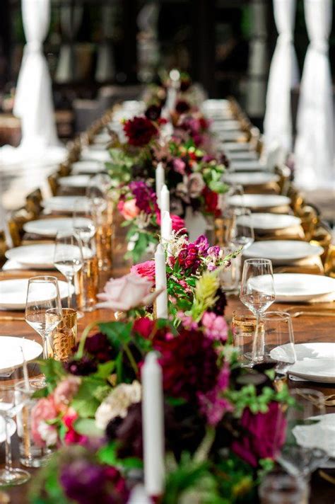 It's not necessary that only exotic flowers are used to make beautiful flower arrangements. Burgundy floral wedding centerpiece - greenery garland ...