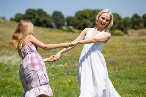Mother And Daughter Dancing In A Meadow Stock Photo Image Of Harmony