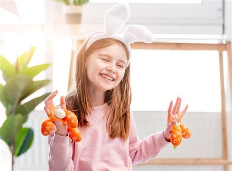 Premium Photo Beautiful Little Girl Holding Painted Eggs In Her Hands