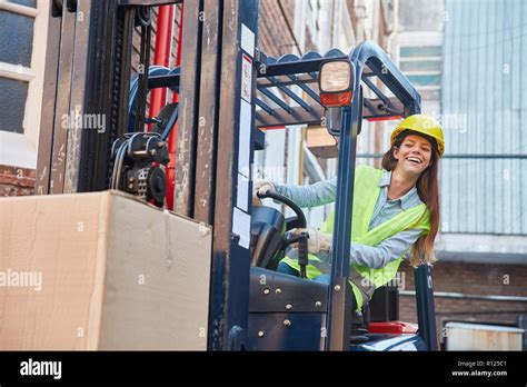 Young woman in logistics. Training to forklift driver on the forklift