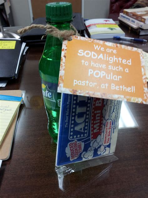 A Bottle Of Soda Sitting On Top Of A Wooden Table Next To A Notepad