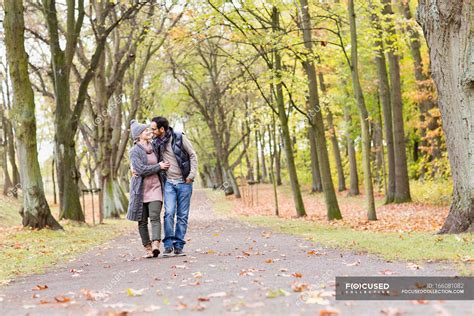 Couple Walking Together In Park — Young Woman Heterosexual Couple