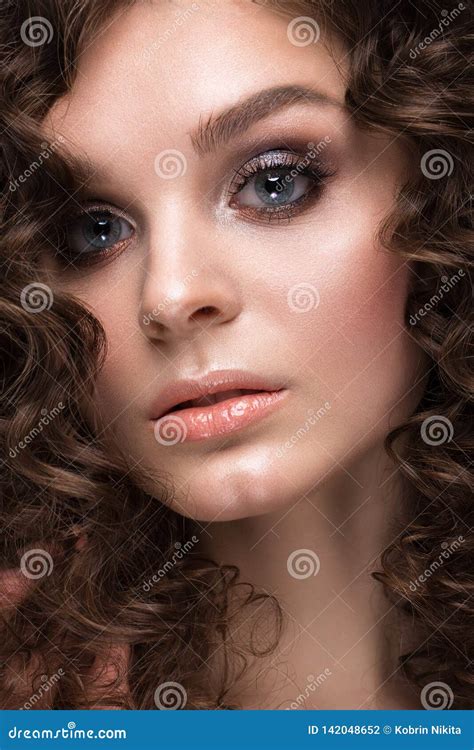 Beautiful Brunette Girl With A Perfectly Curly Hair And Classic Make Up Beauty Face Stock