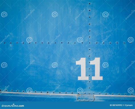 Number Eleven In White With Blue Background And Rivets Stock Photo