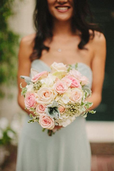 Maybe you would like to learn more about one of these? Bridesmaid wearing pastel green dress holding pink flowers ...