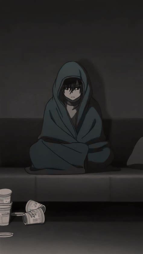 A Person Sitting On A Couch In The Dark With A Blanket Over Their Head
