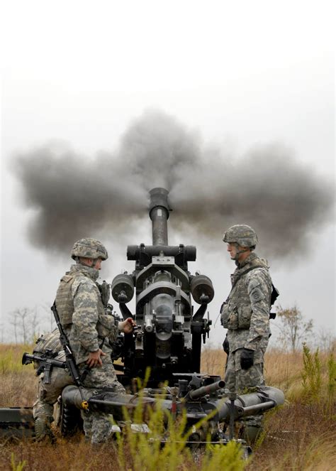 Us Army Soldiers Fire A Howitzer During A Training Exercise On Fort