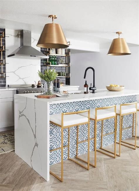 These sleek designs will encourage you to give your kitchen a contemporary refresh. Gold counter stools sit at a white and blue mosaic tiled ...