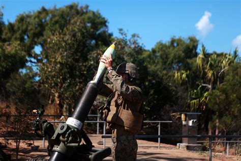 A Us Marine Loads A Round Into An M327 120mm Mortar During A Four Day