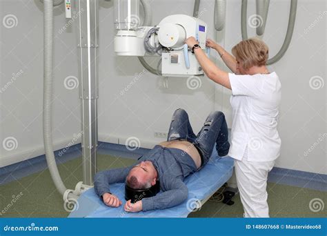 Radiologists Performing X Ray On Patient Technician Setting Up Machine
