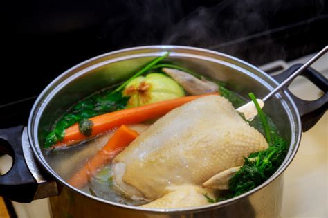 Then cover the pan, turn the heat to low, and cook 15 to 20 minutes or until all. Boiling chicken broth with vegetables in steel pot on gas ...