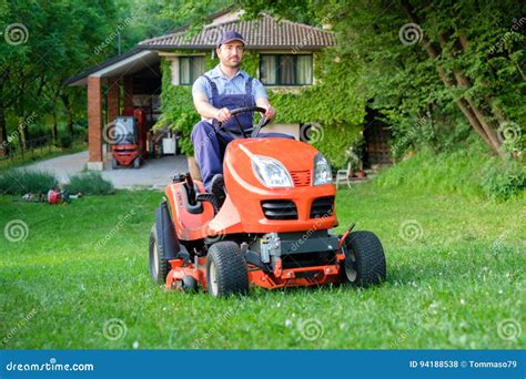 Gardener Driving A Riding Lawn Mower In Garden Stock Photo Image Of