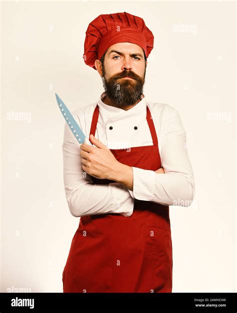 Cook With Proud Face In Burgundy Apron And Chef Hat Cooking And Professional Culinary Concept