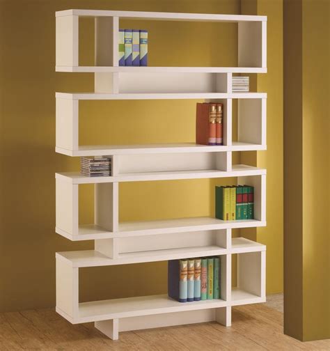 A White Book Shelf With Books On Top And Two Stacks Of Books In The Bottom