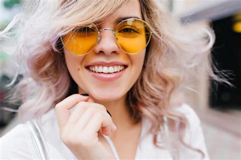 Free Photo Close Up Portrait Of Fair Haired Laughing Girl Wearing Trendy Yellow Sunglasses