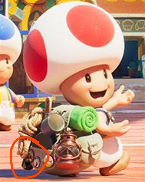 In The Mario Movie Teaser Poster Captain Toad S Backpack Has Two Pins Of Fossil Falls And