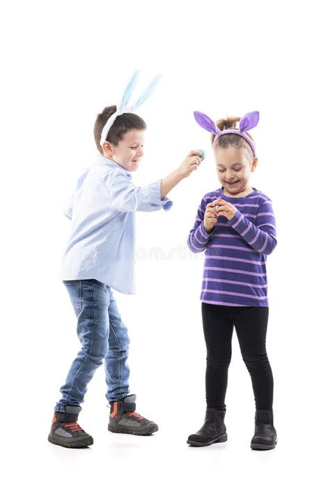 Older Brother And Younger Sister Kids With Bunny Ears Playing Easter