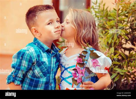 Sister Are Kissing Her Brother On The Cheek Warm Hugs In Nature