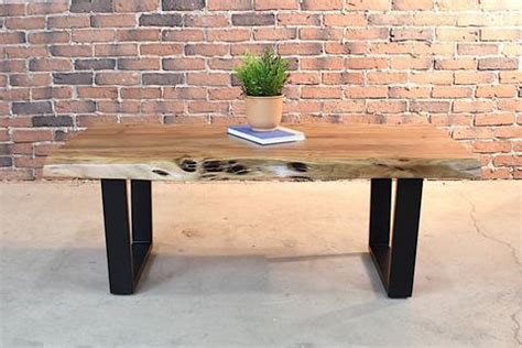 Solid acacia wood, slick brass legs, cutout handles. Acacia Natural Live Edge Wood Coffee Table with Black U ...