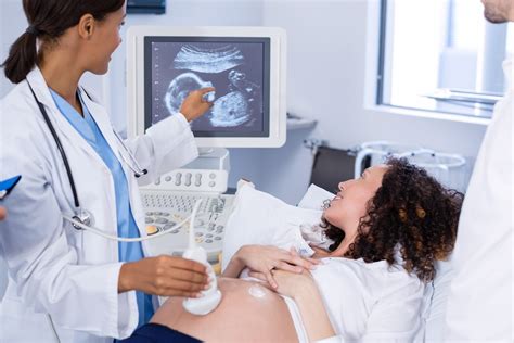 Technician Performing Ultrasound On Pregnant Woman Imaging Center Minimally Invasive Services