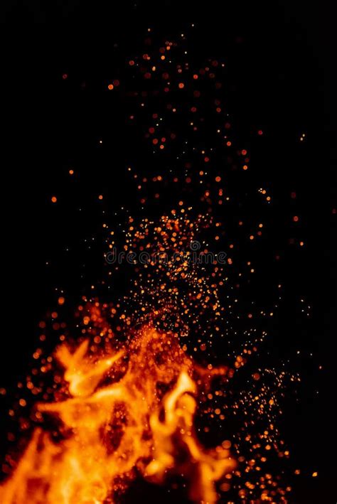 Flame Of Fire With Sparks In The Air Over A Dark Night Stock Image